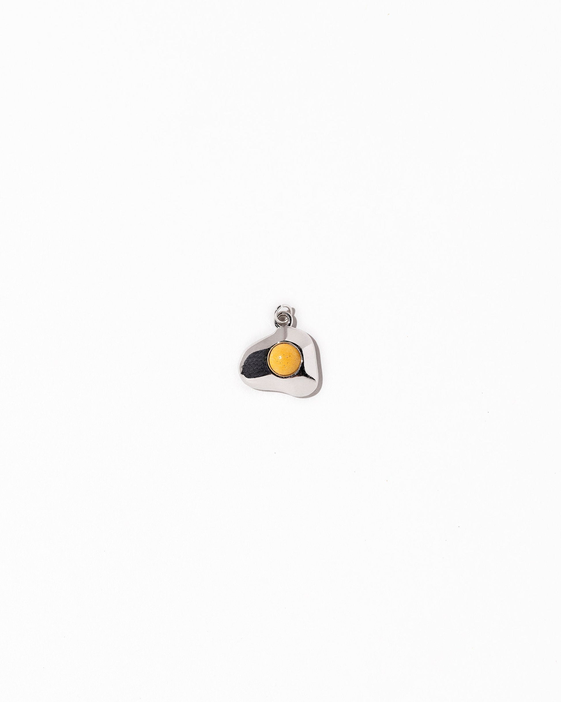 Sunny Side Up Egg Charm Eight on light colored background.