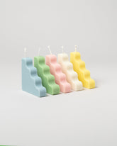  Group of SIG Step Candles on light color background.