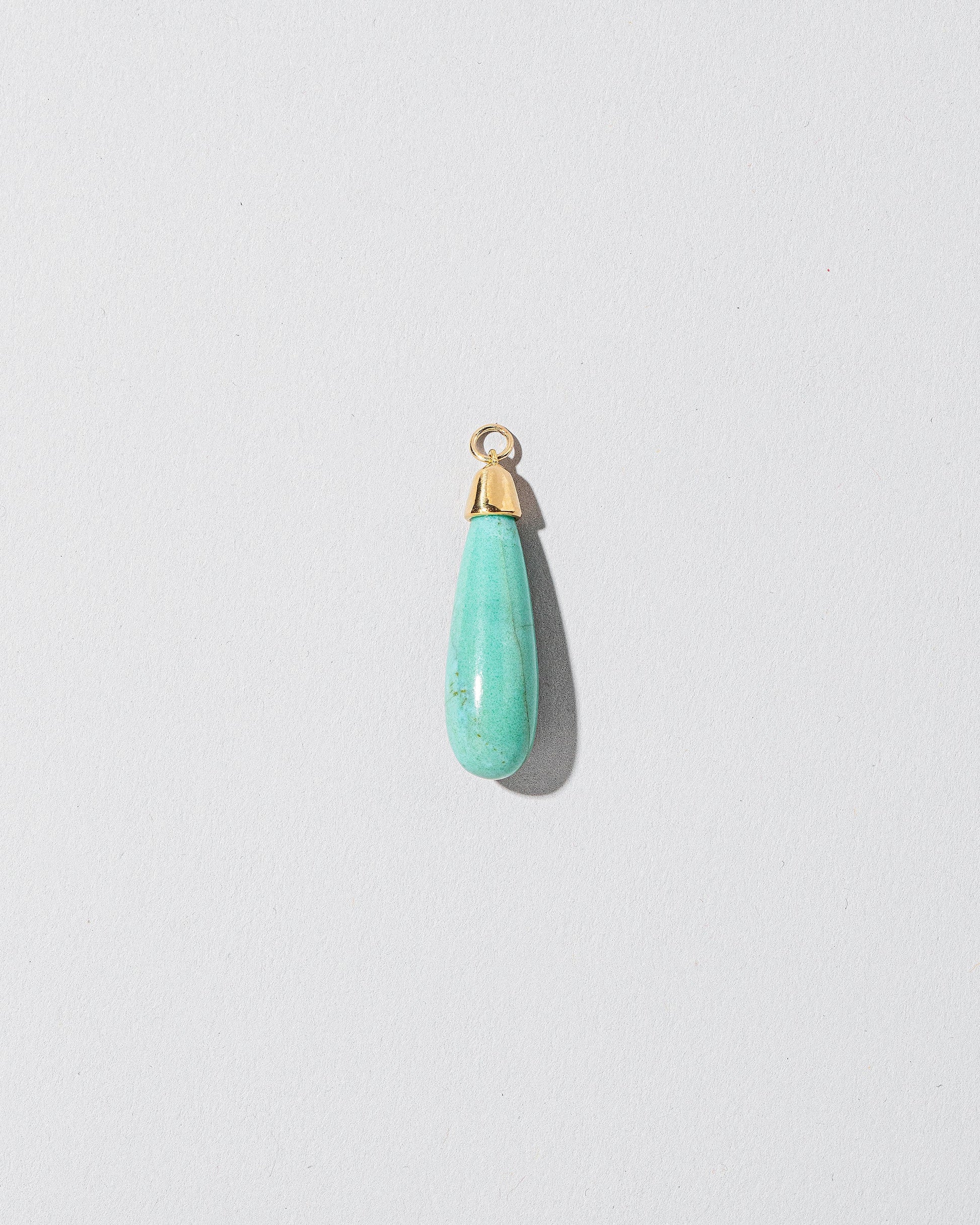  Turquoise Drop Pendant on light color background.