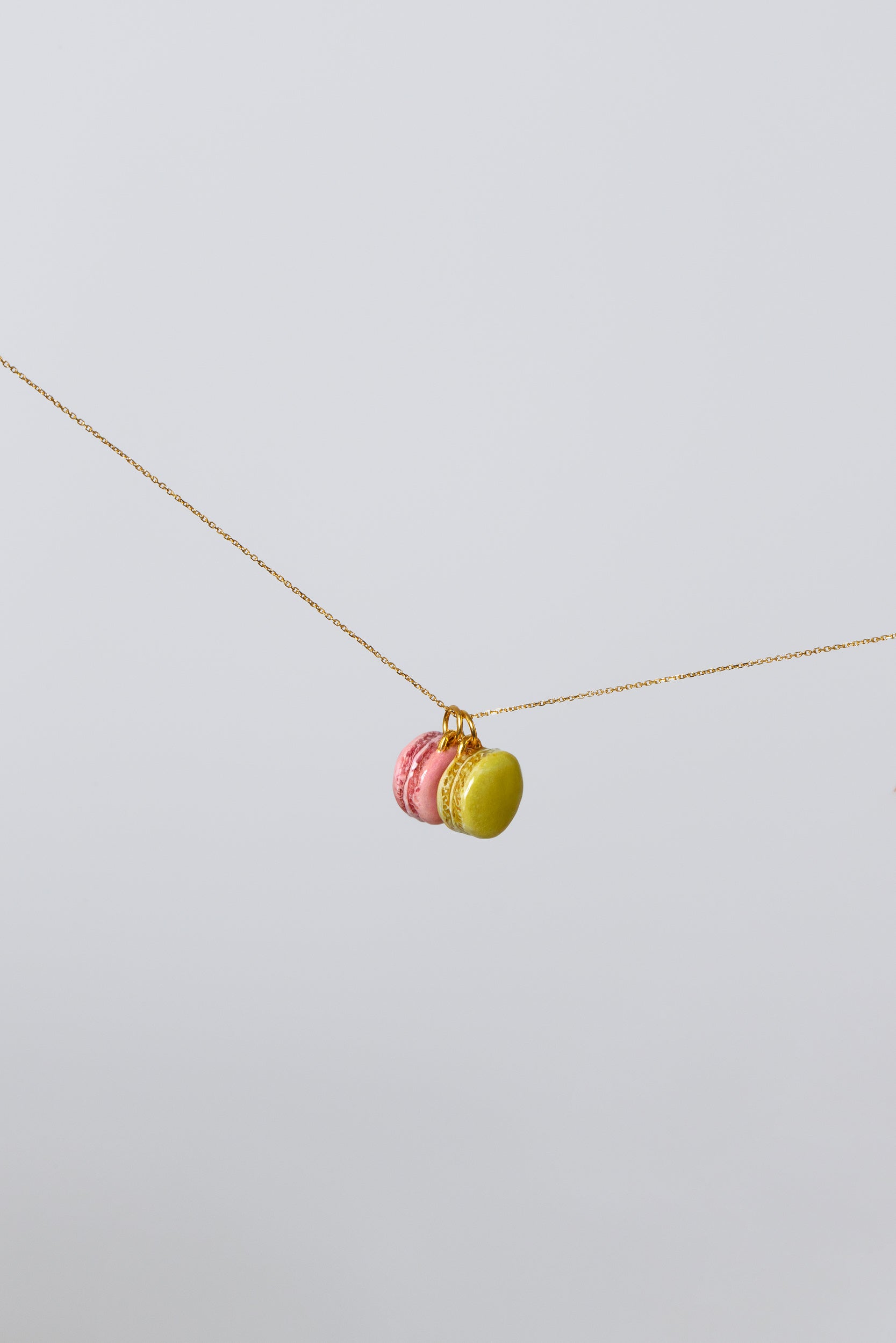 Product photo of Macaron Charms on a gold chain on light co