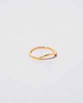 View from the side of the Gold Square Wire Mini Curve Band on light color background.