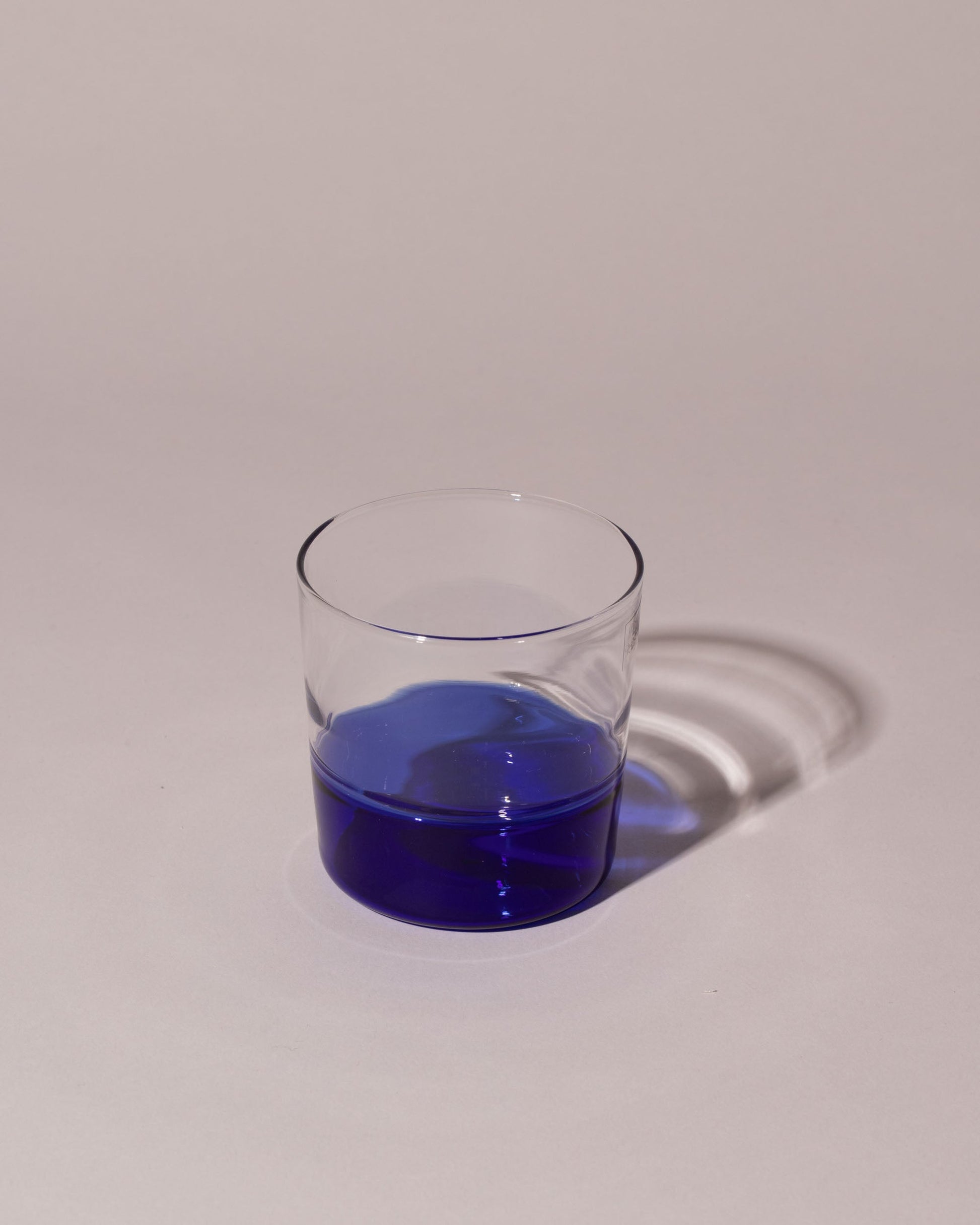 Ichendorf Milano Blue/Clear Light Colore Water Glass on light color background.