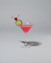 Spills Cosmopolitan Martini on light color background.
