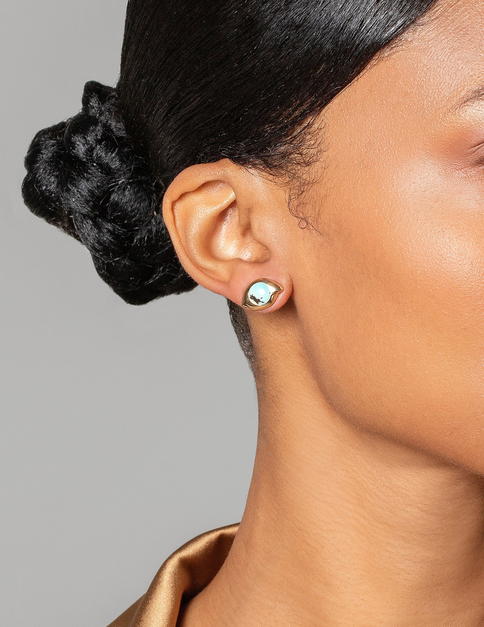 Turquoise Transformation Earrings on model.