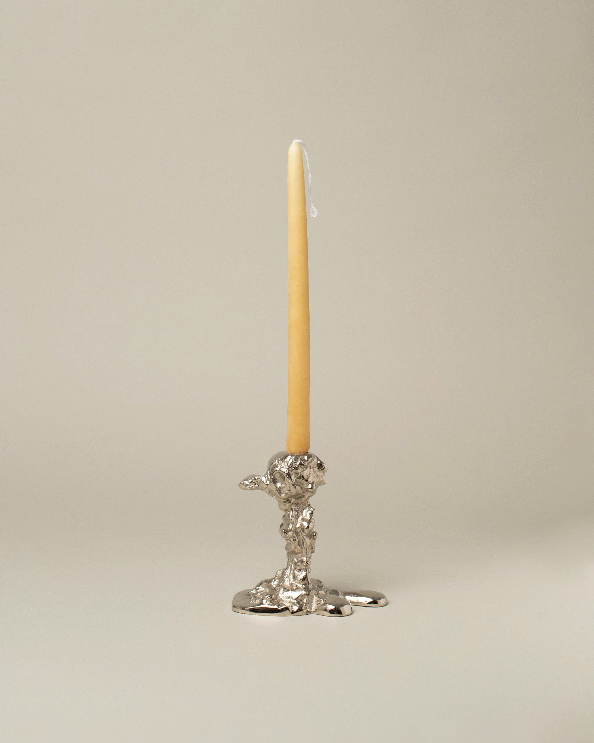 POLSPOTTEN Silver Small Drip Candle Holder on light color background.