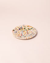 Closeup details of the La Ceramica Vincenzo Del Monaco Colored Drops Dessert Dish on light color background.
