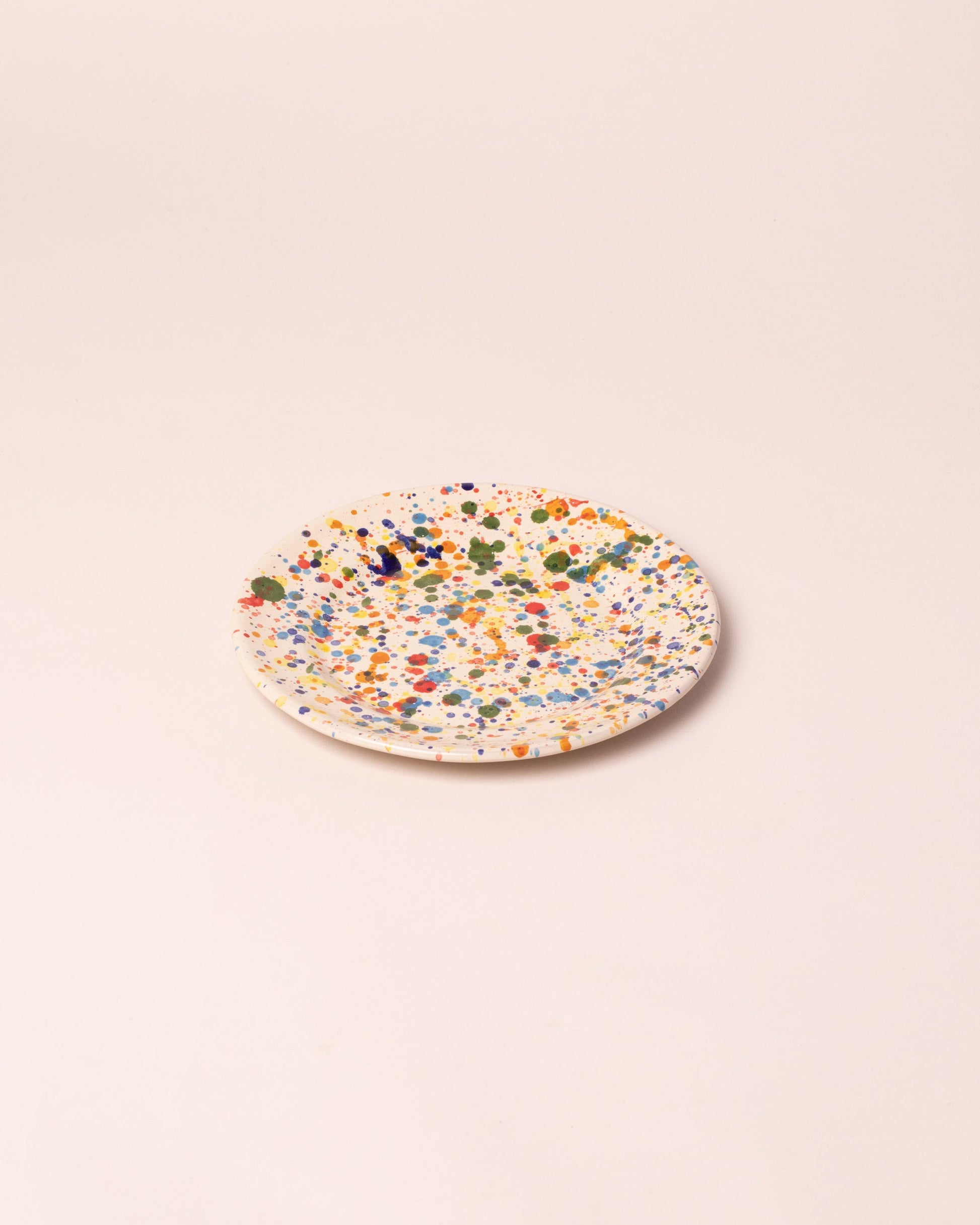 Closeup details of the La Ceramica Vincenzo Del Monaco Colored Drops Dessert Dish on light color background.