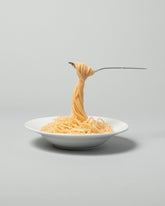  Spills Pasta on light color background.