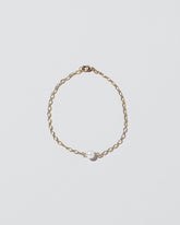 One Pearl Station Bracelet Open Oval Chain on light color background.