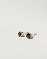 Sapphire Sun & Moon Stud Earrings on light color background.