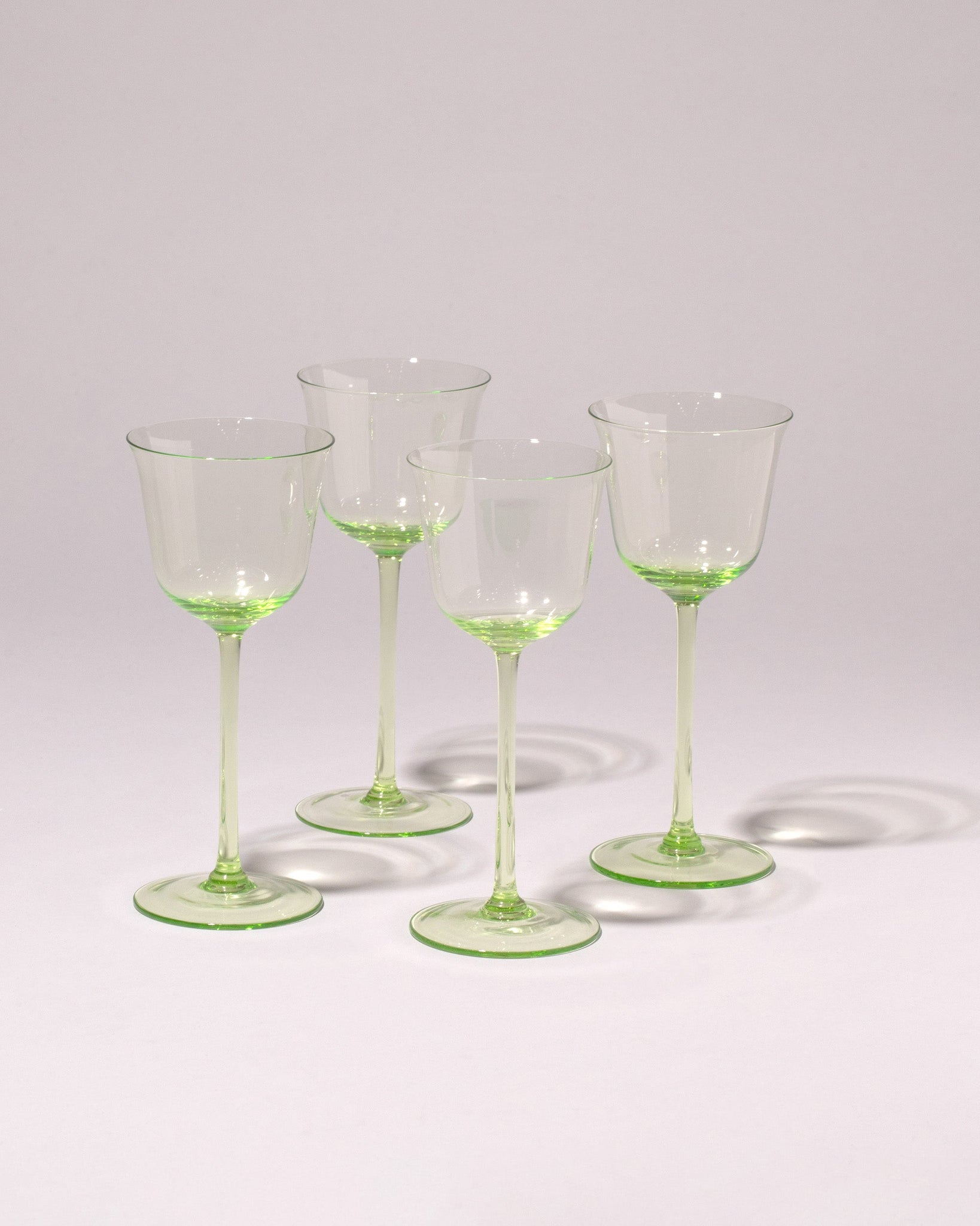 Group of Serax Grace Wine Glasses by Ann Demeulemeester on light color background.