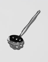  Izabel Lam Slotted Spoon on light color background.