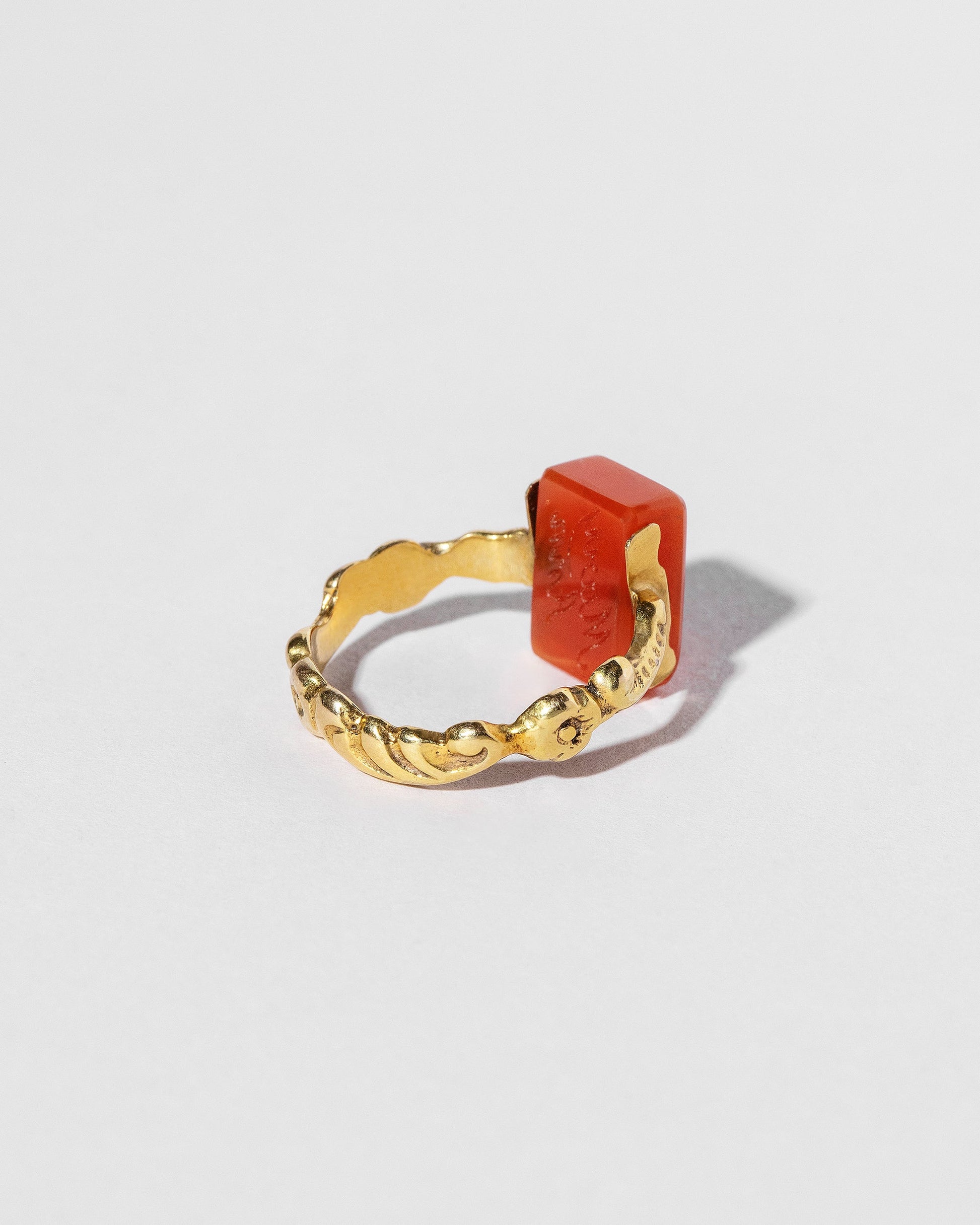 View from the back of the Antique Carnelian Flip Ring on light color background.