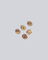  Cinnamon Roll Charms on light color background.