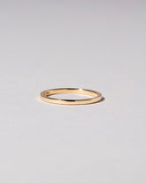 Gold 1.5mm Square Wire Band on light color background.