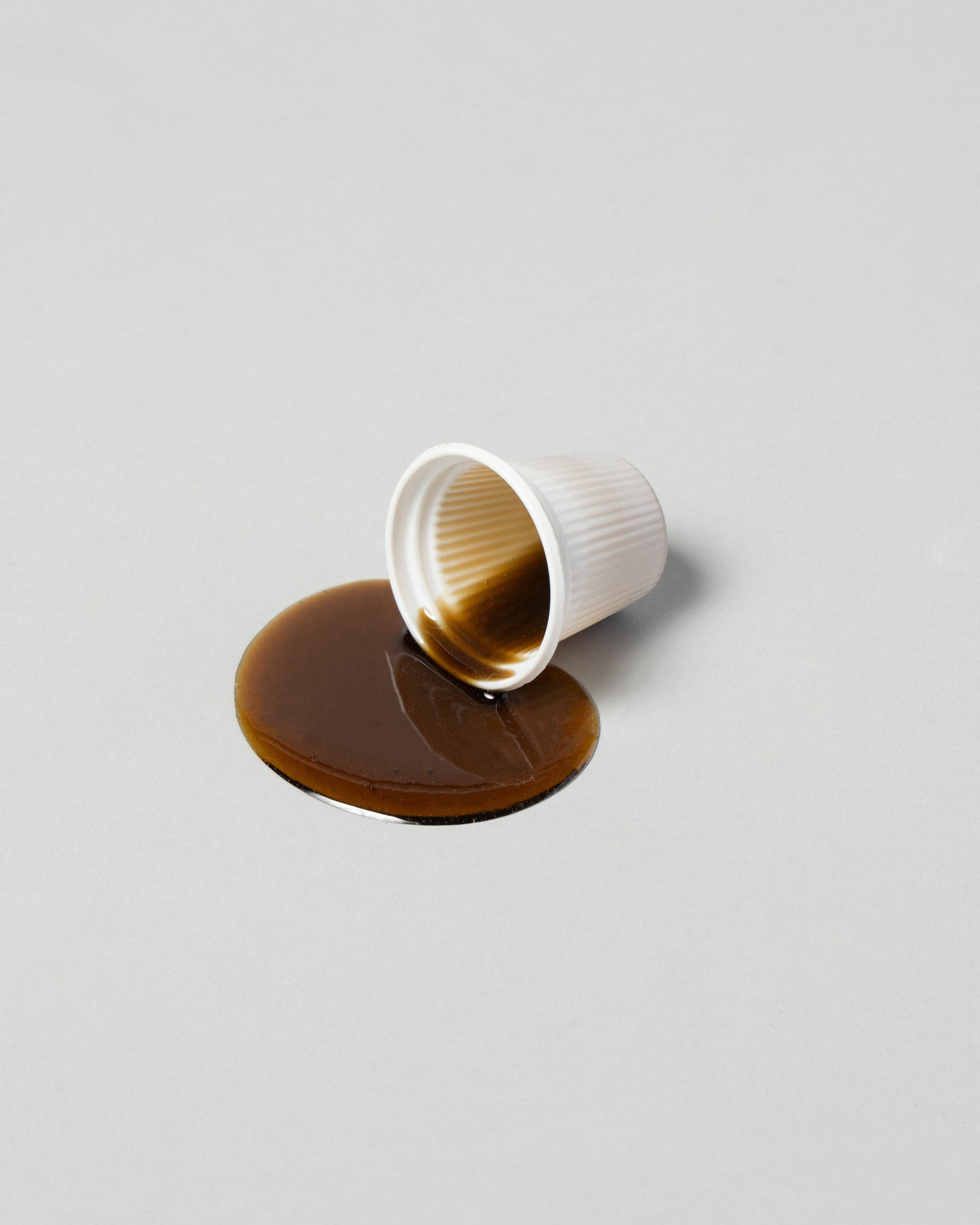 Closeup detail of the Spills Coffee Shot Breakfast on light color background.
