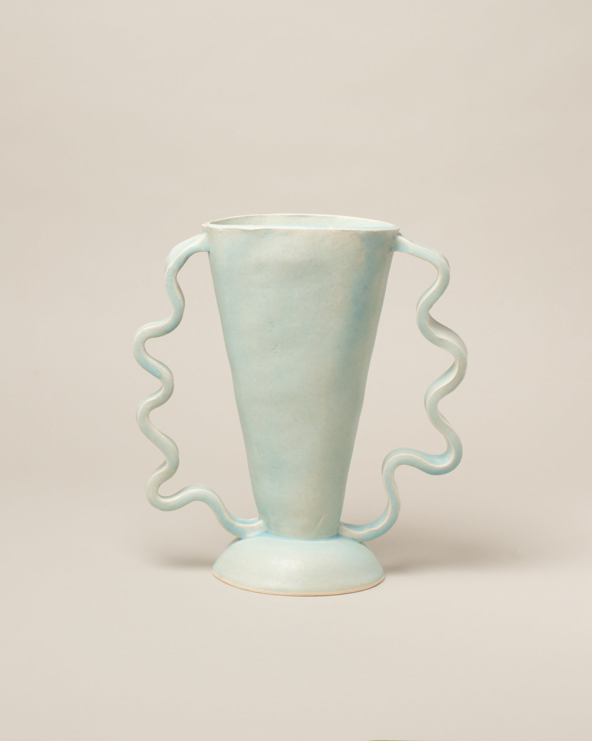 Morgan Peck Stone Blue Stretch Vase on light color background.
