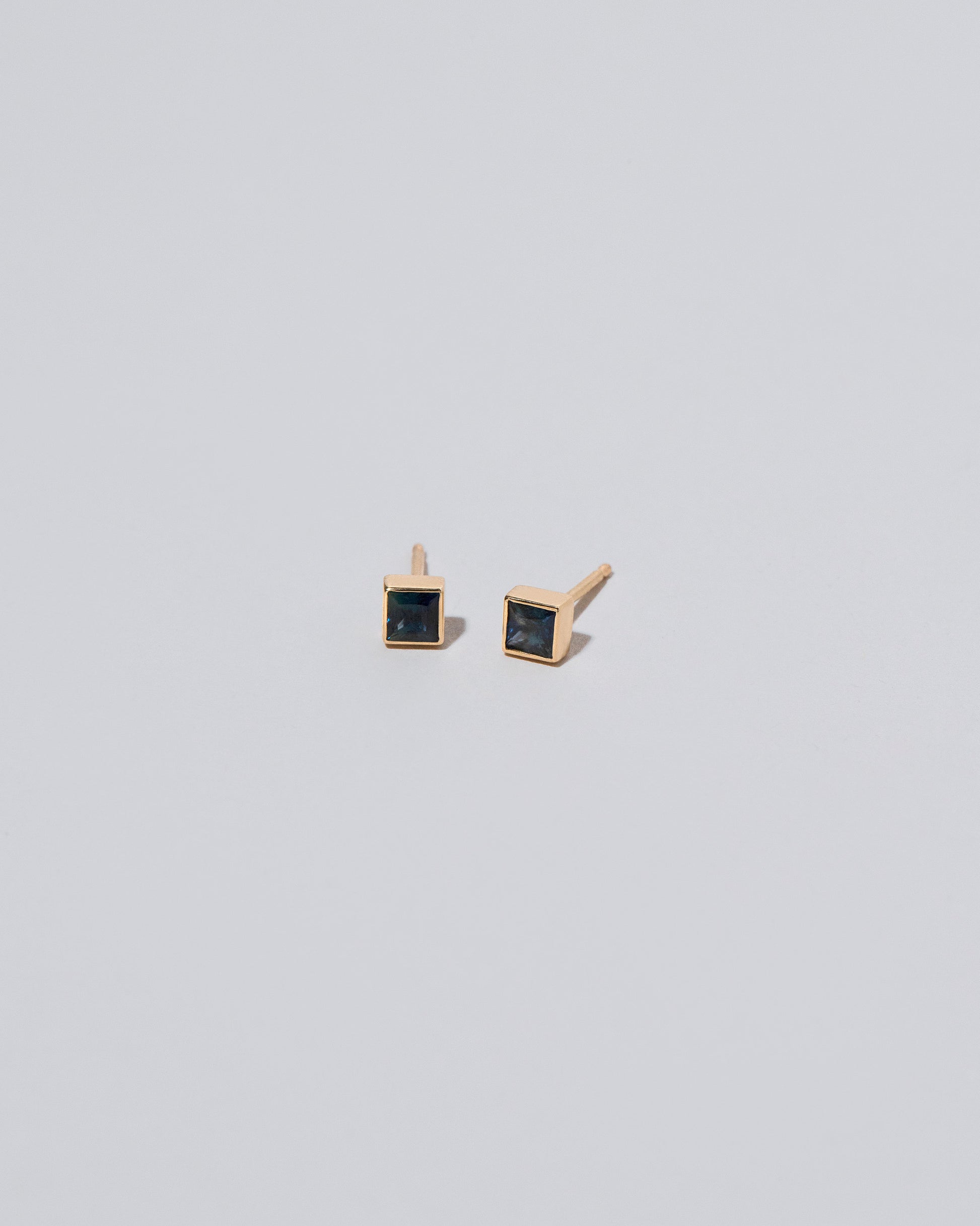Square Stud - Teal Sapphire on light color background.