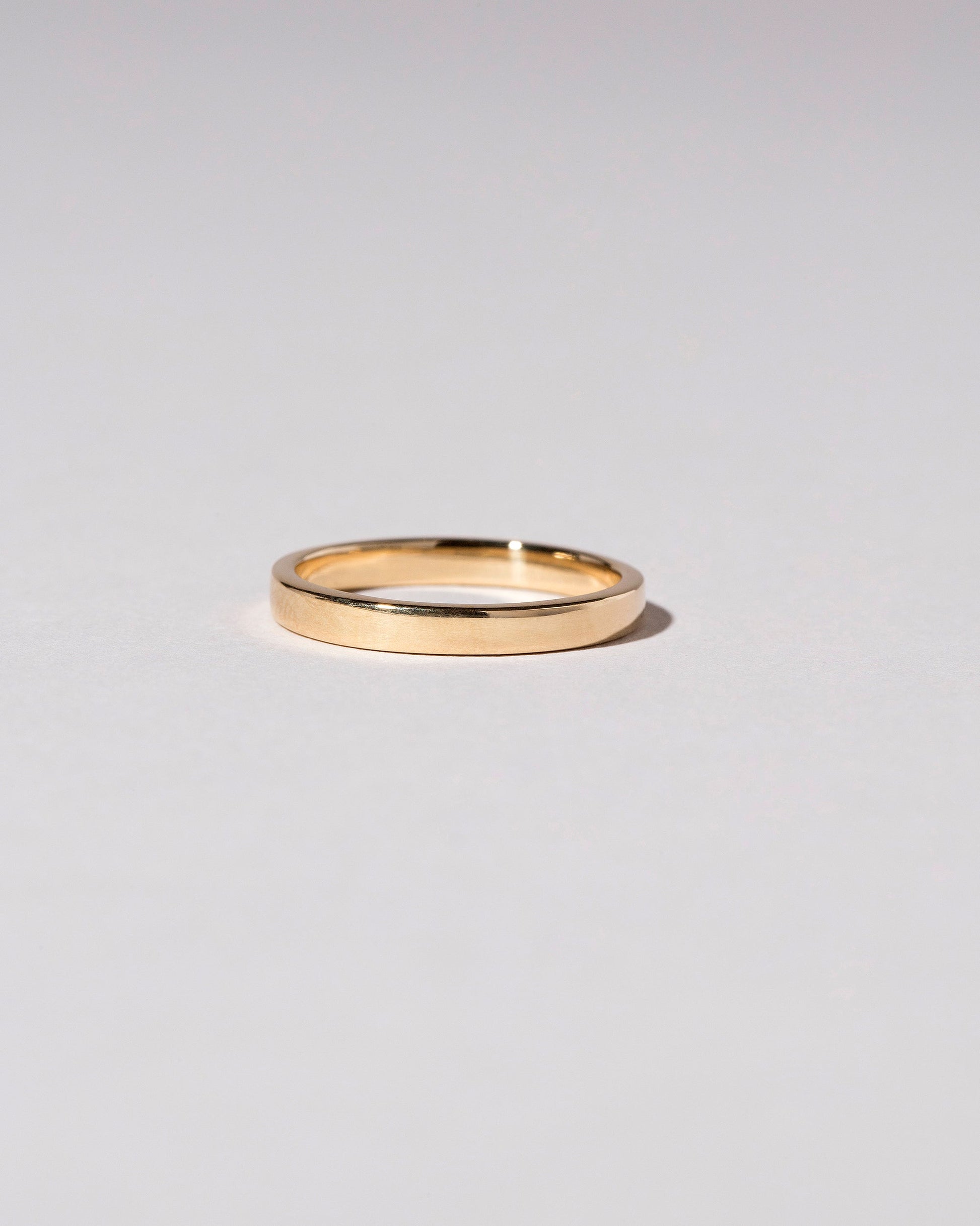 Gold 2.5mm Square Wire Band on light color background.
