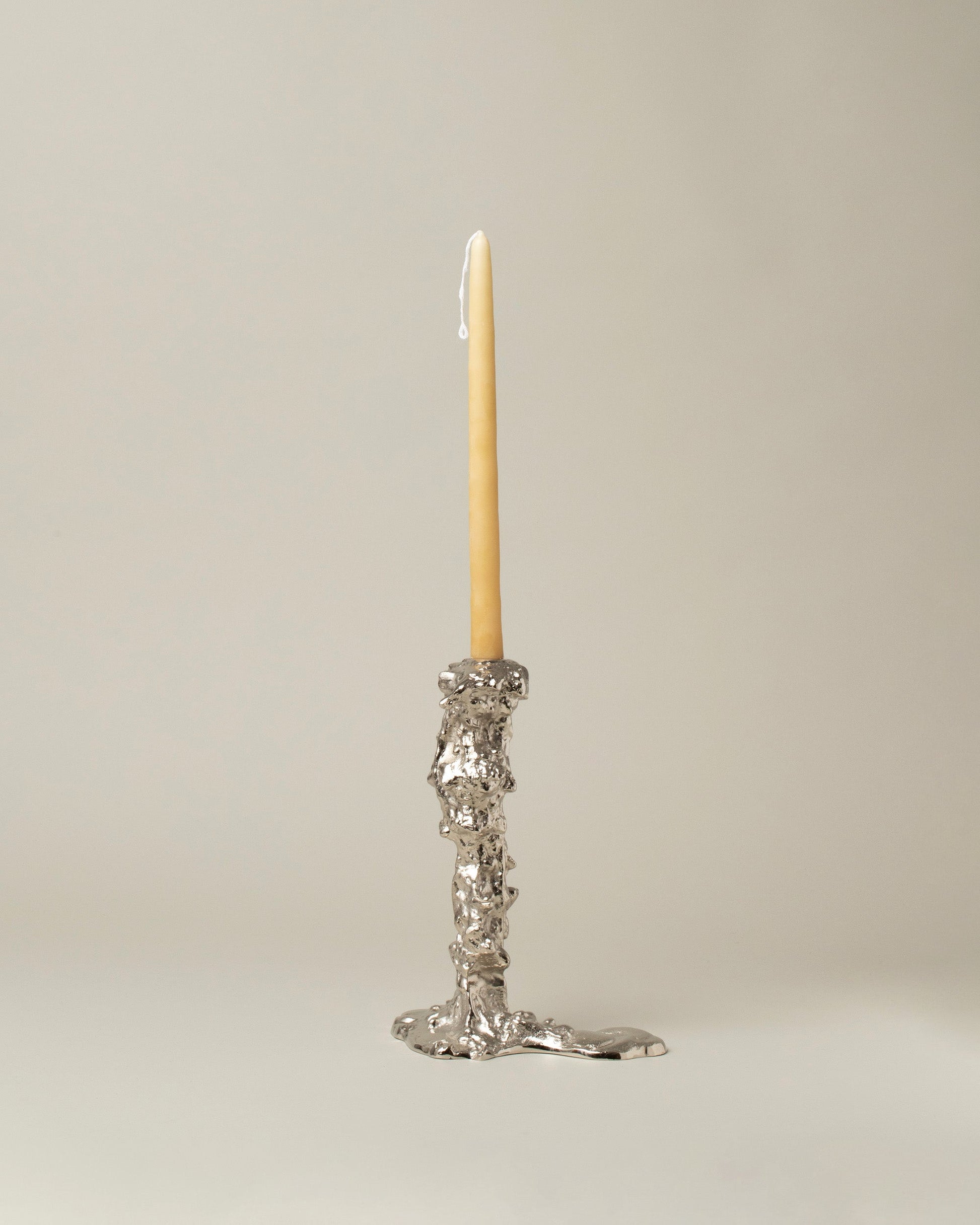 POLSPOTTEN Silver Medium Drip Candle Holder on light color background.