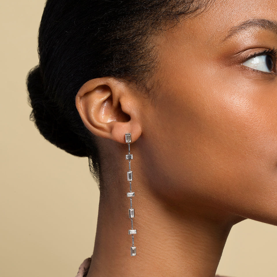 product_details::Diamond Baguette Drop Earrings on model.