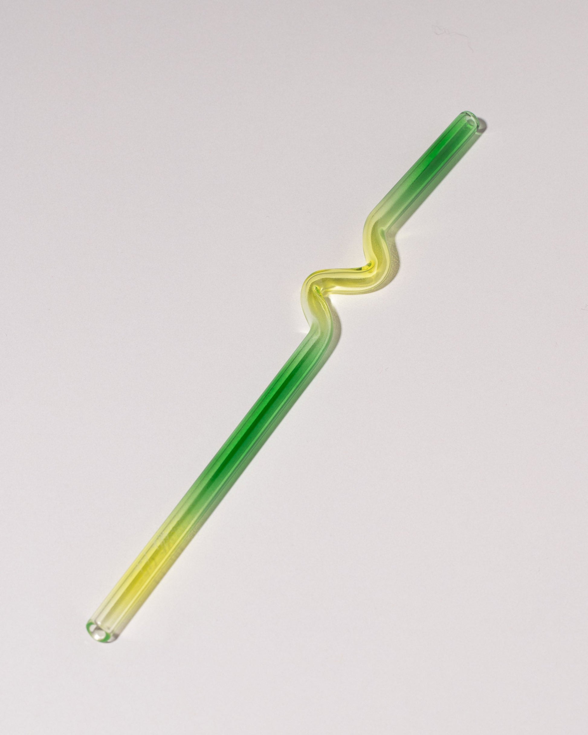  Misha Kahn Yellow and Green Suck It Up Glass Straw on light color background.