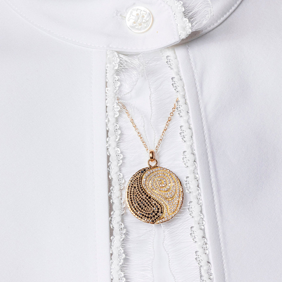 product_details::Editorial photo of Duality Medallion worn on white blouse.