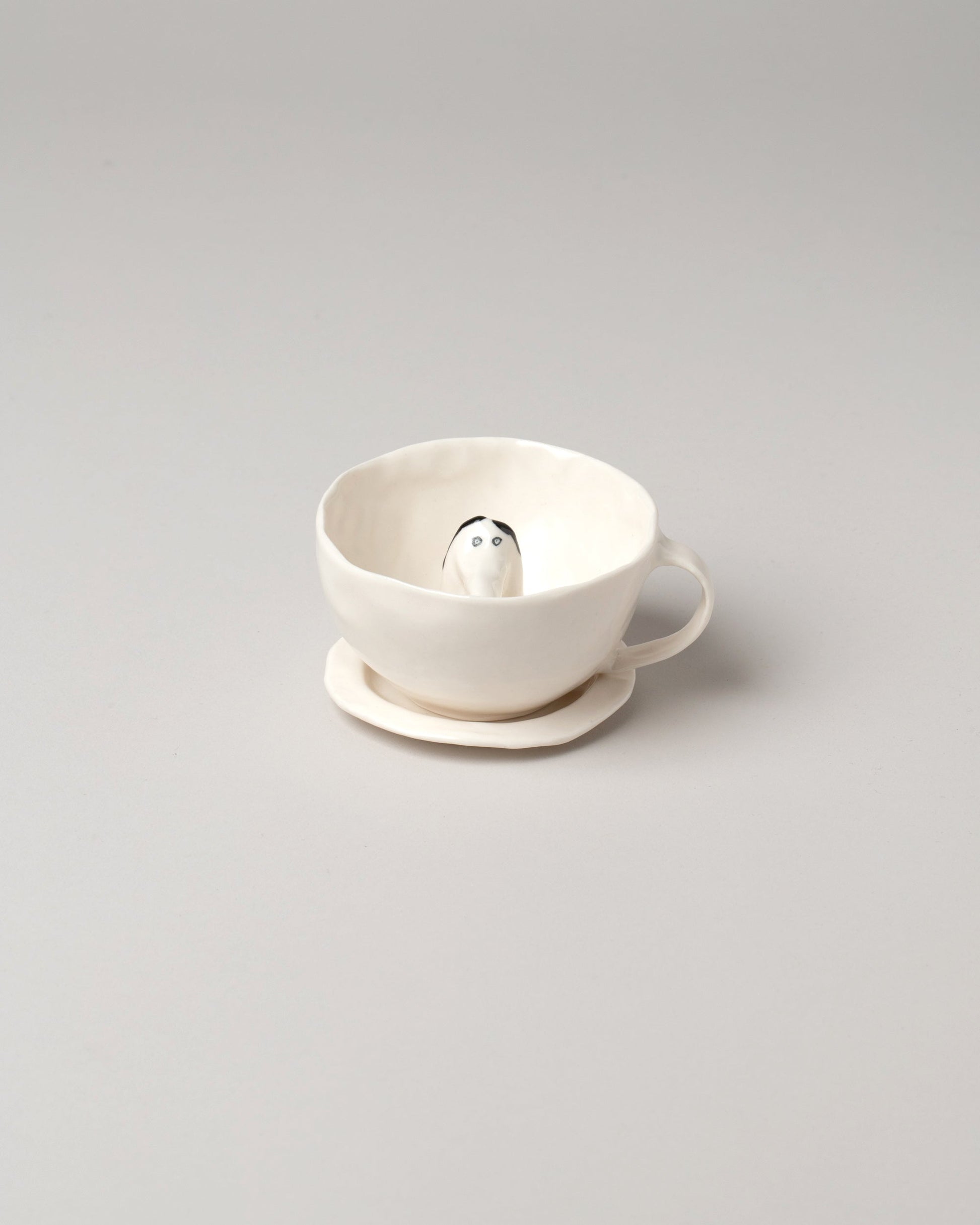 Eleonor Boström Dog Tea Cup & Saucer on light color background.