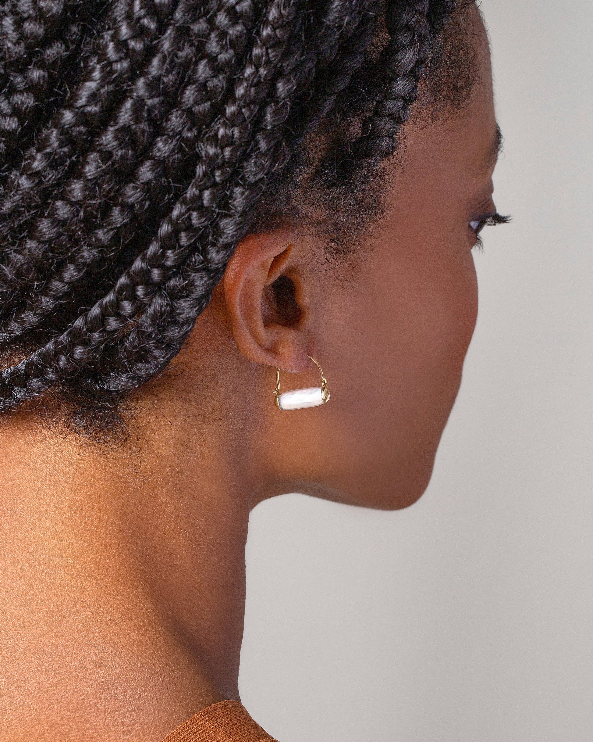 Pearl Hoop Earrings on model.