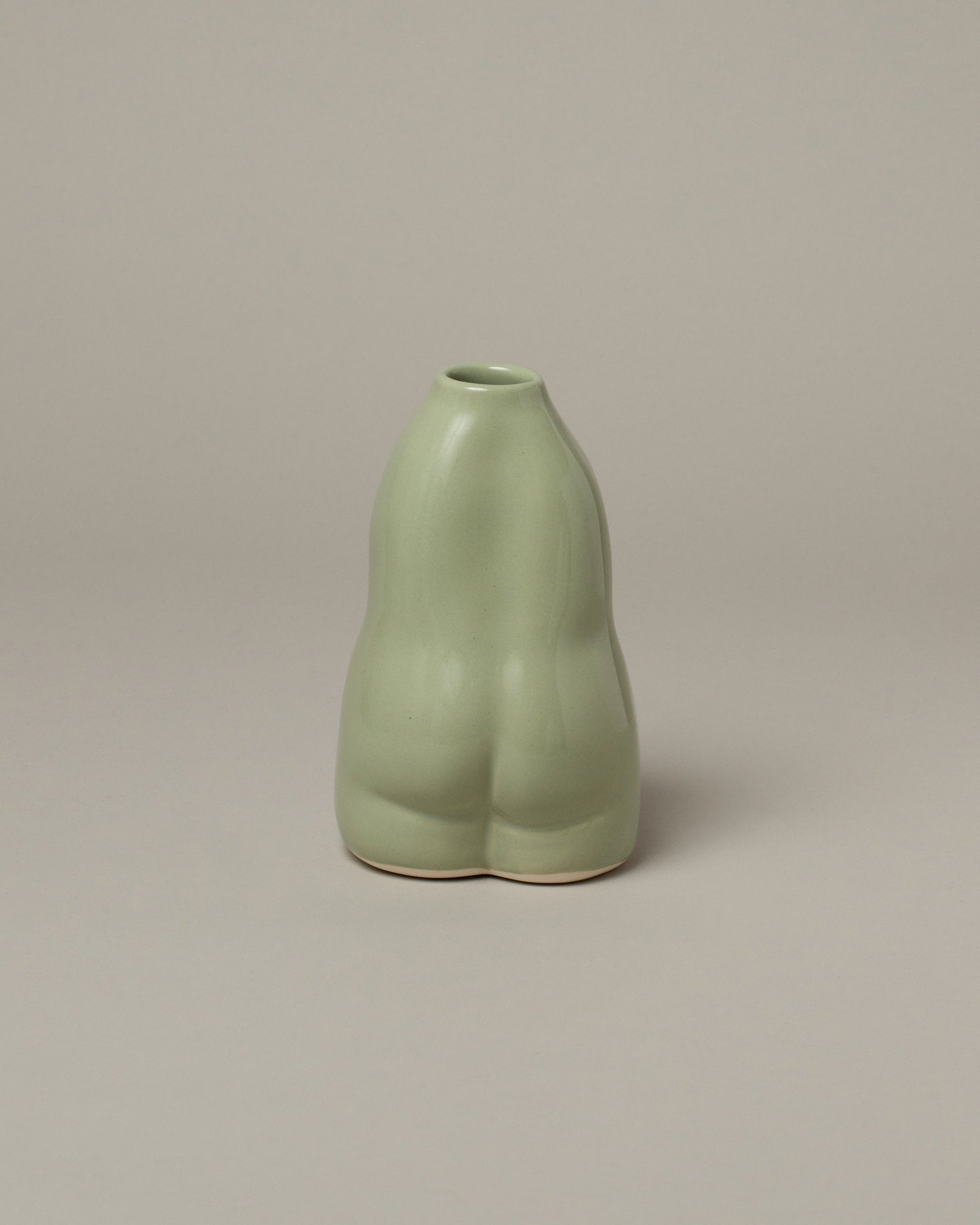 View from the back of the Rachel Saunders Pistache Woman Vase on light color background.