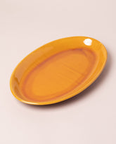 La Ceramica Vincenzo Del Monaco Caramel Yellow Oval Serving Dish on light color background.