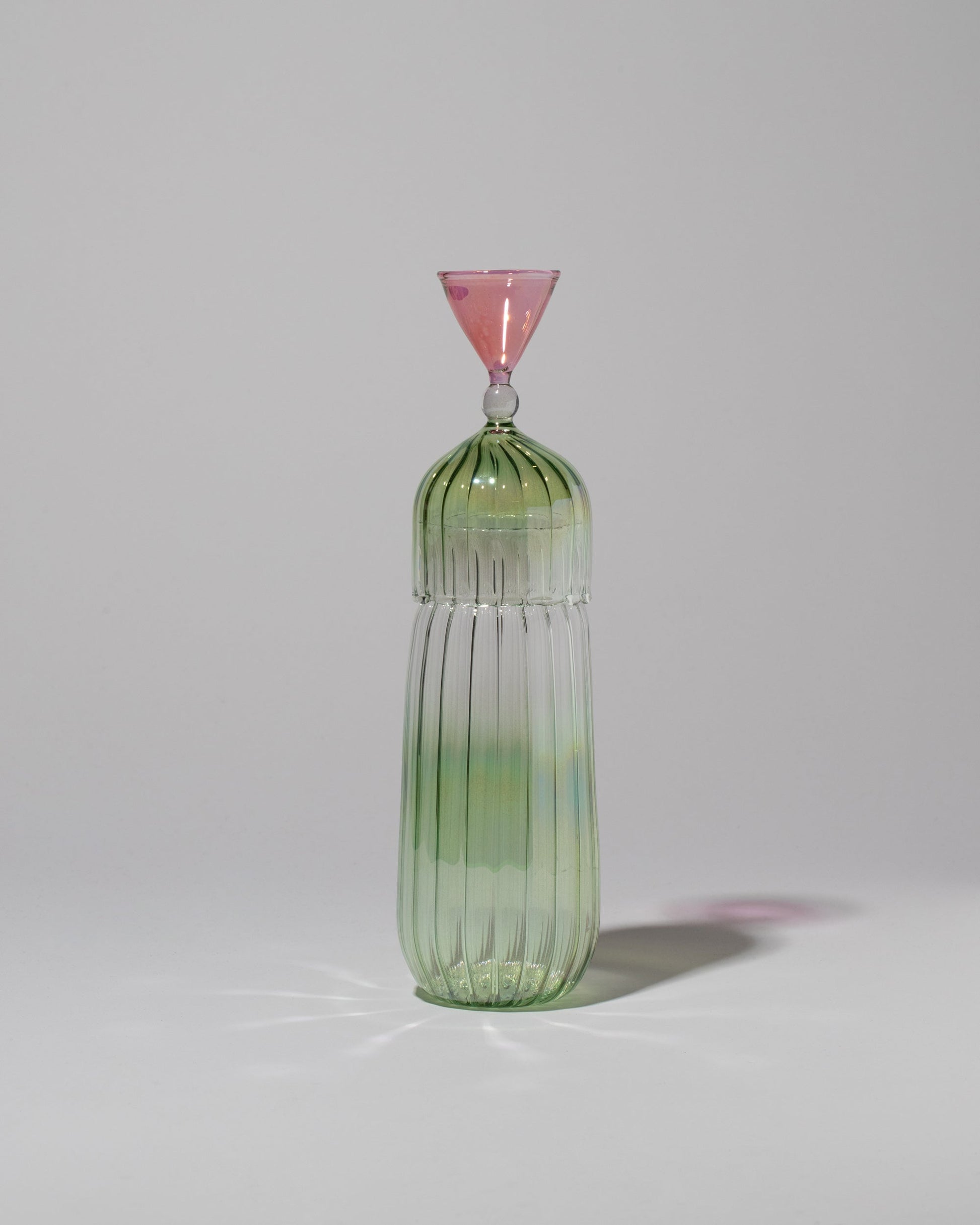 Serena Confalonieri Calypso Bottle & Glass in Green on light color background.