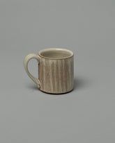 Jeremy Ayers Combed Mug on light color background.