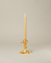 POLSPOTTEN Gold Small Drip Candle Holder on light color background.