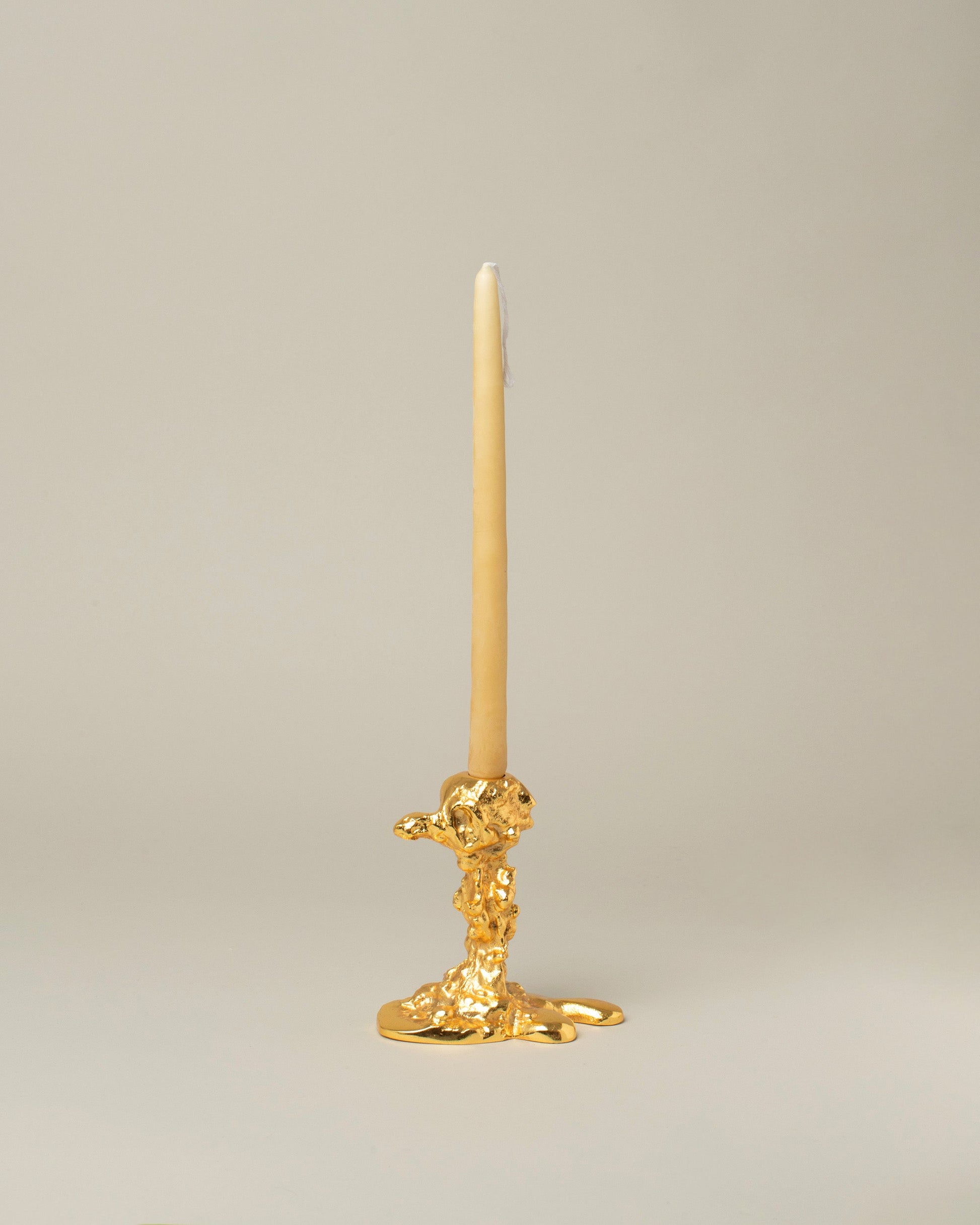 POLSPOTTEN Gold Small Drip Candle Holder on light color background.