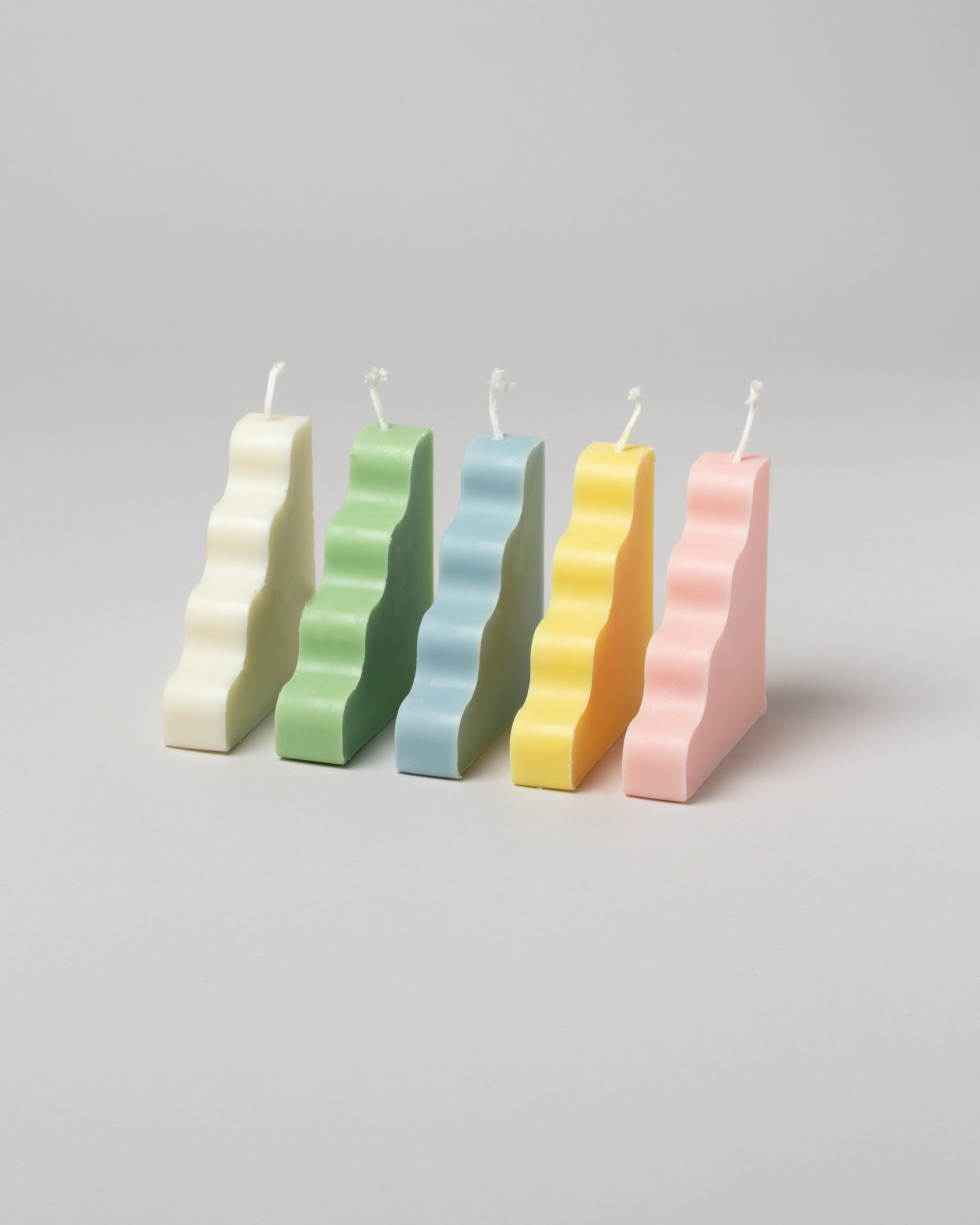  Group of SIG Step Candles on light color background.
