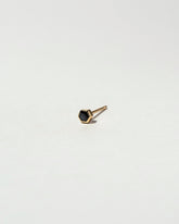 Black Spinel Hexagon Stud Earring Single on light color background.