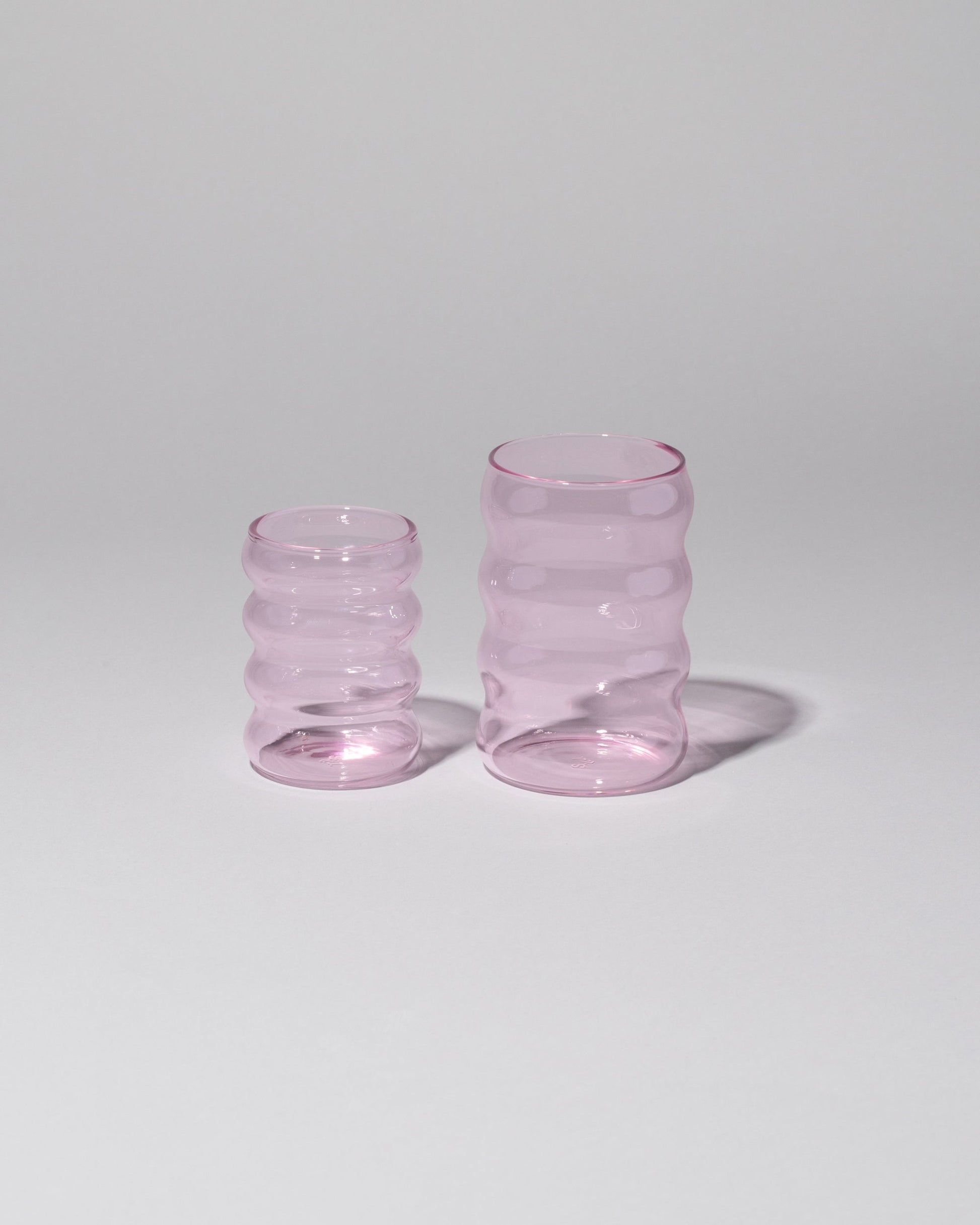 Group of Sophie Lou Jacobsen Small Pink and Large Pink Single Ripple Cups on light color background.
