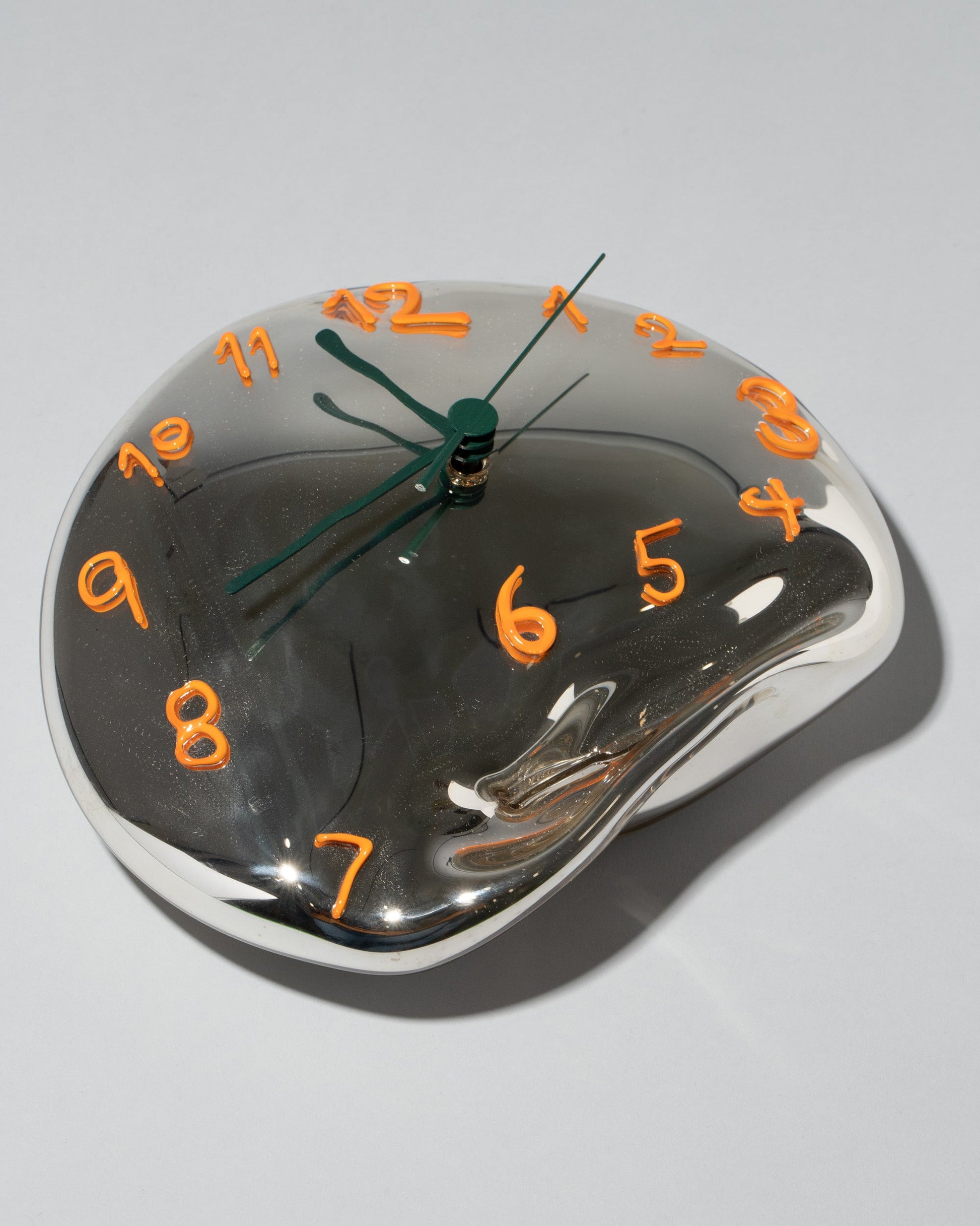 Silje Lindrup Orange Two Glass Wall Clock on light color background.