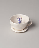 Eleonor Boström Blue Spots Cat Tea Cup with Saucer on light color background.