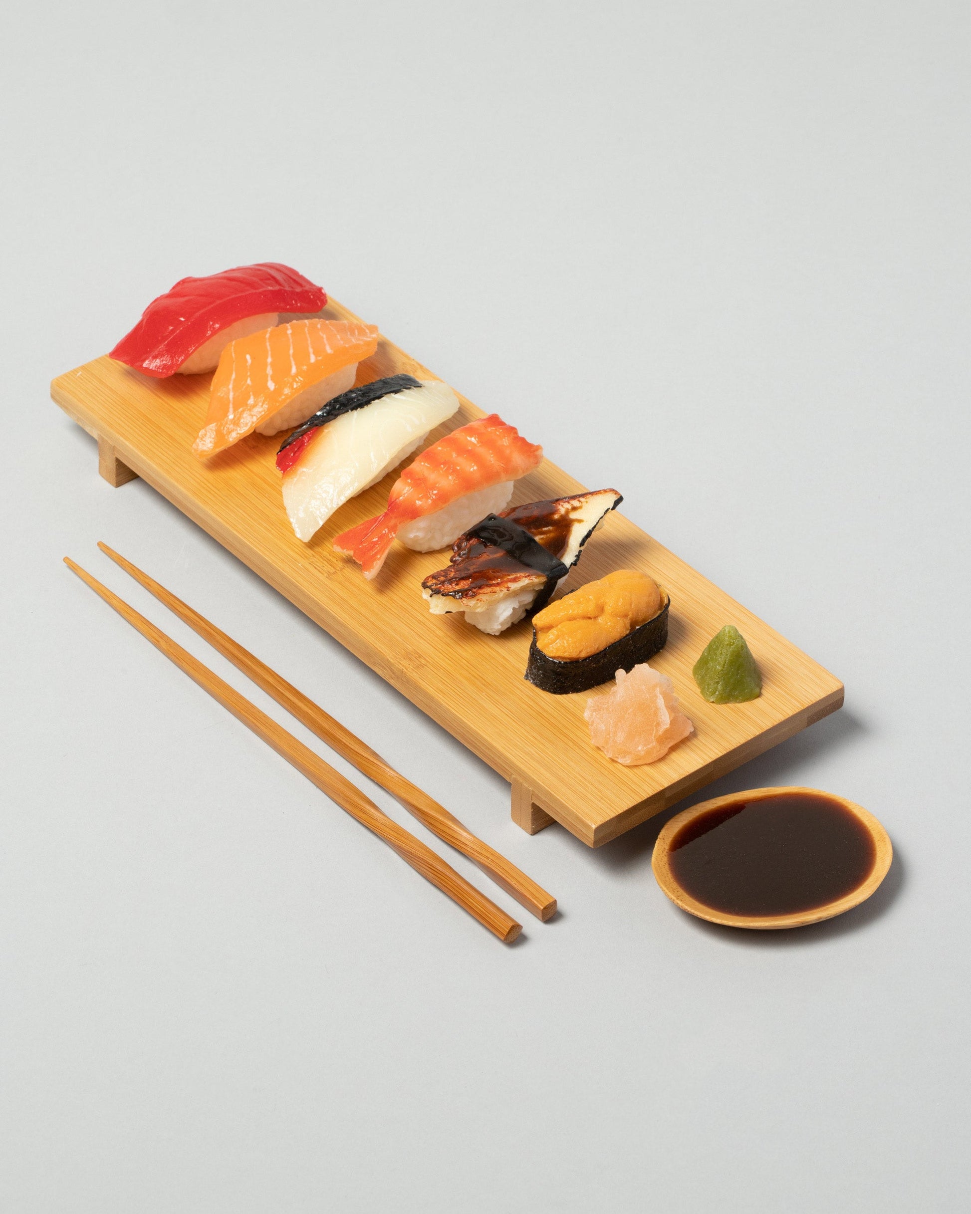Spills Sushi Board Sushi Board on light color background.