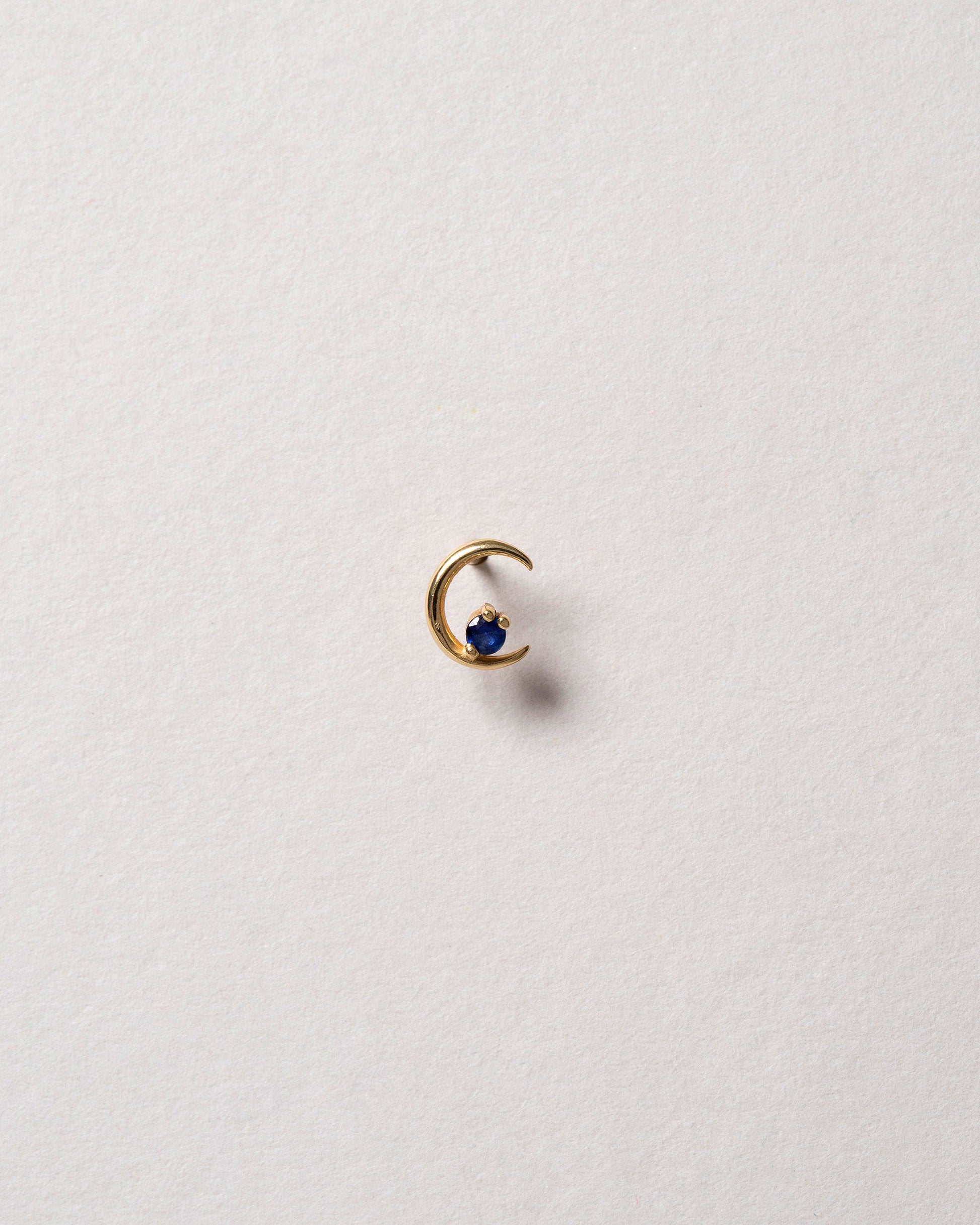 Right Sapphire Moon Ray Stud Earring Single on light color background.
