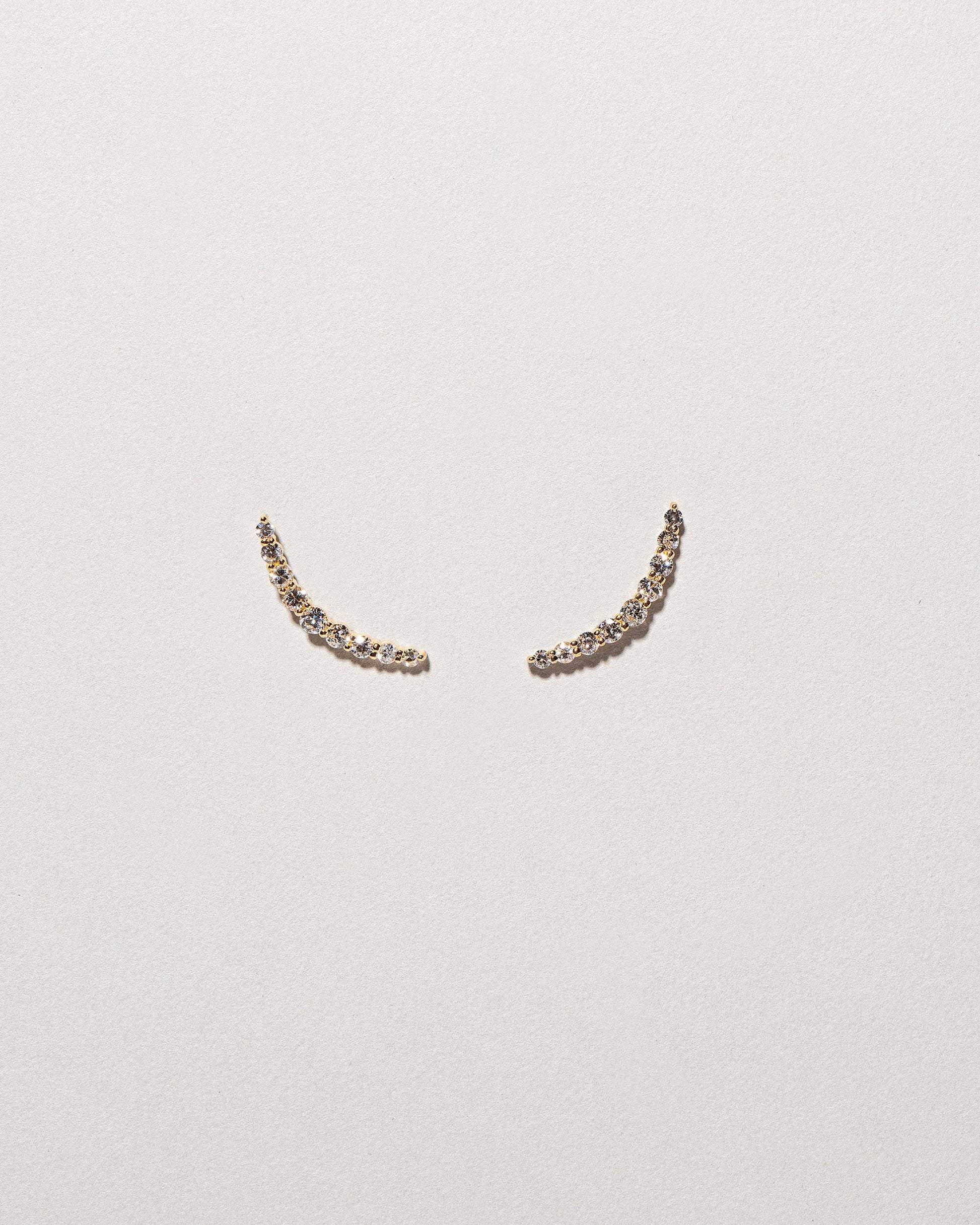  Crescent Ear Climber Studs on light color background.