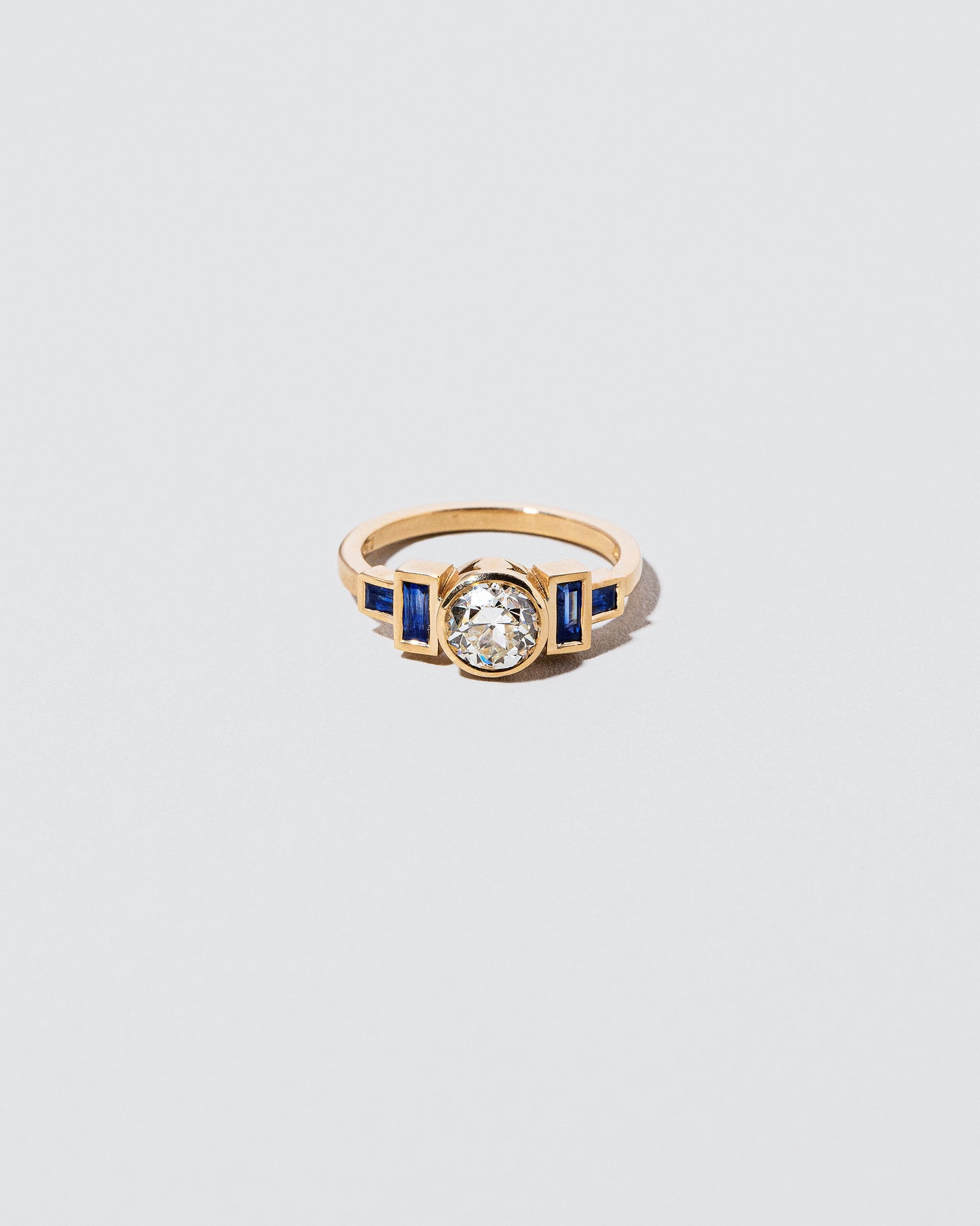 White Diamond & Blue Sapphire Third Eye Ring on light color background.