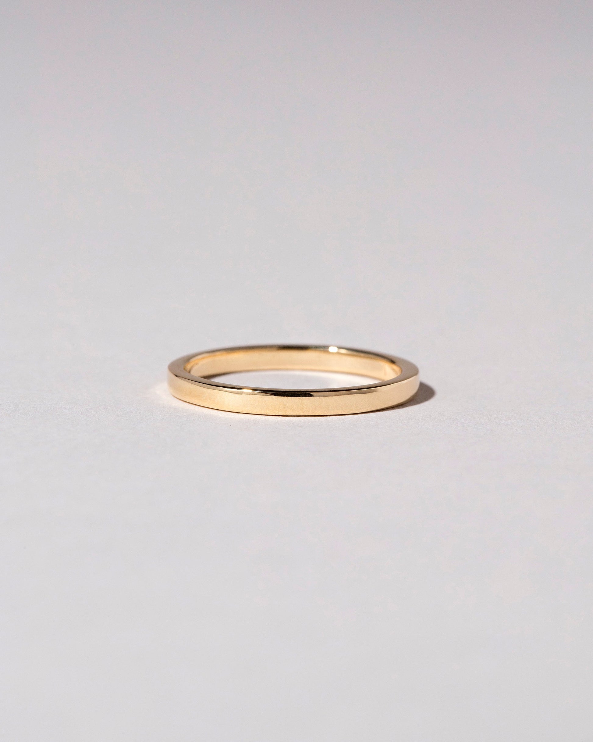 Gold 2mm Square Wire Band on light color background.