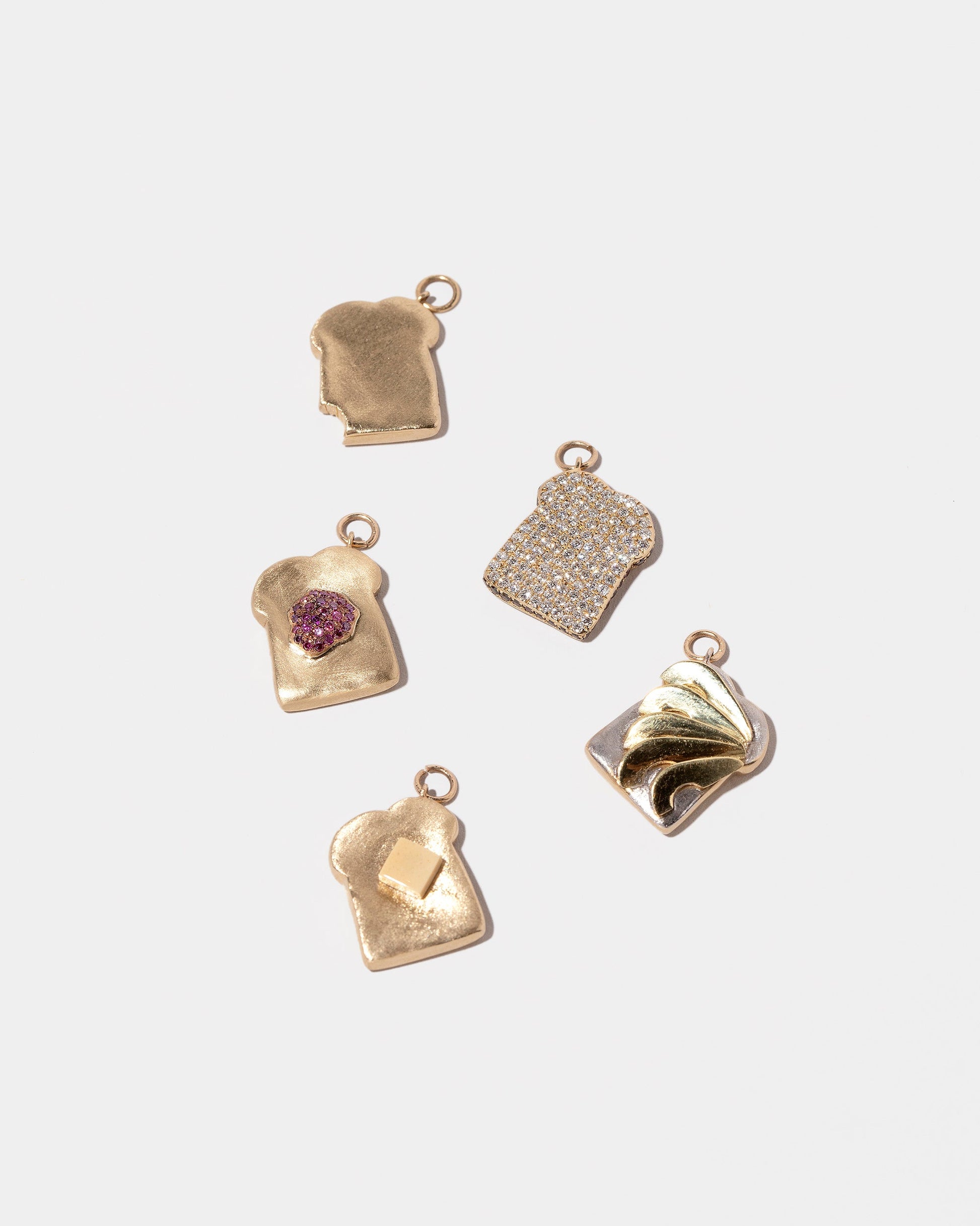Group of Toast Charms on light colored background.
