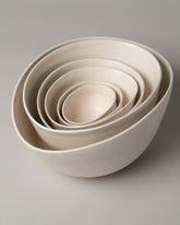 Group of Eric Bonnin Off-White Sylvia Bowl #3, Sylvia Bowl #1/4, Sylvia Bowl #4, Sylvia Bowl #1/2, Sylvia Bowl #2 and Sylvia Bowl #1 on light color background.