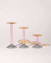 Group of Ichendorf Milano Small, Medium and Large Grey/Pink/Amber Rainbow Candleholders on light color background.