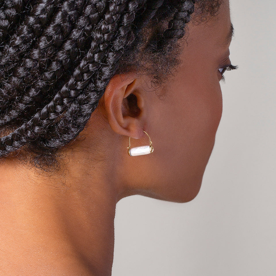 product_details::Pearl Hoop Earrings on model.