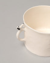 Closeup detail of the Eleonor Boström Bathtub Coffee Mug on light color background.